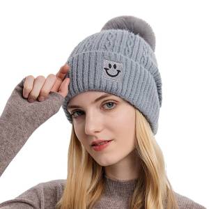 Warm pom pom hat with smily face detail
