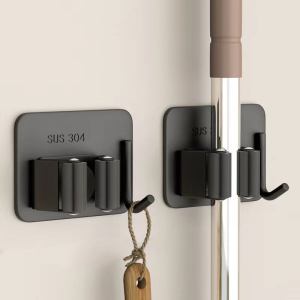 Self-adhesive mop clip holder